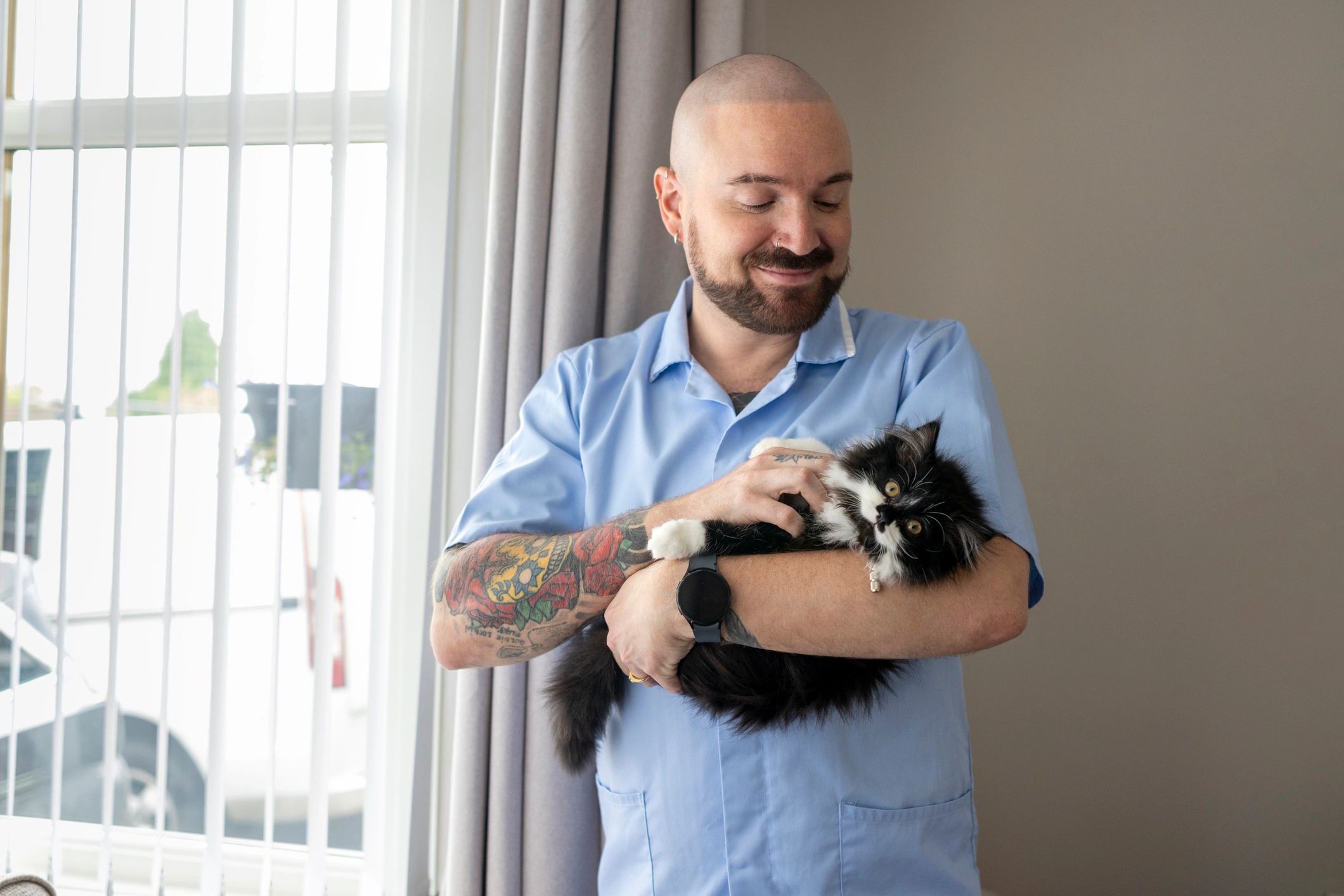 Person holding a cat at home